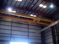 Typical used/refurbished low headroom, top-riding, double girder crane with double girder, underhung trolley.